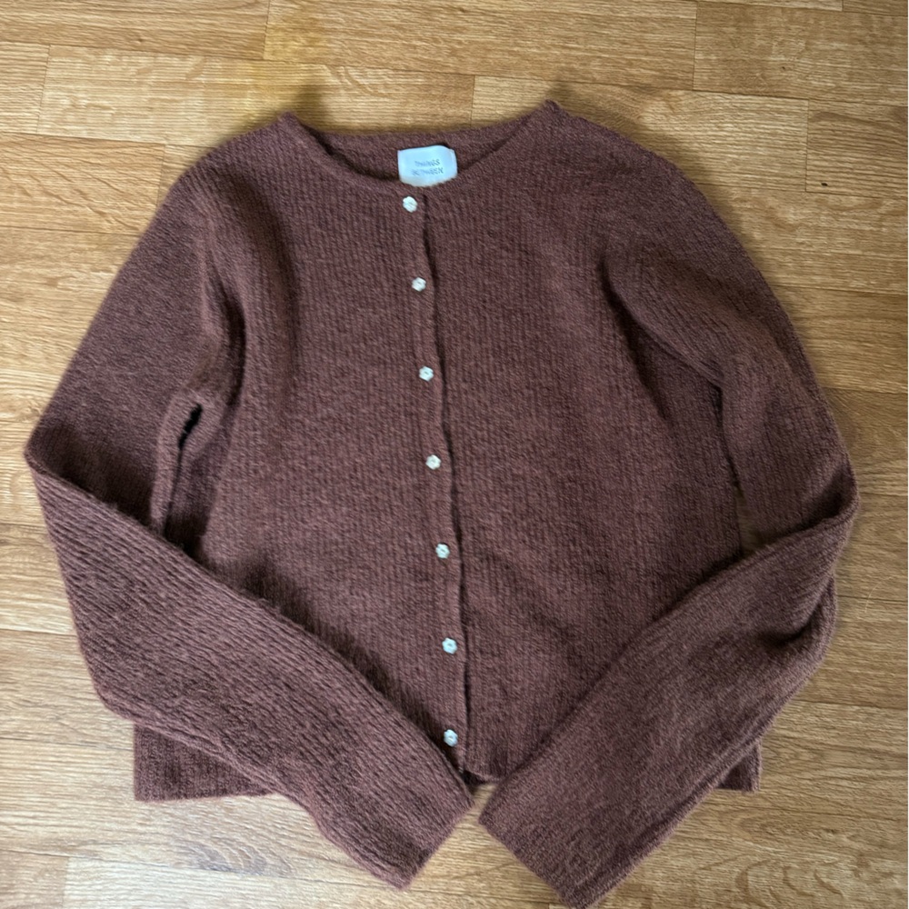 Things between small brown cardigan, flower buttons